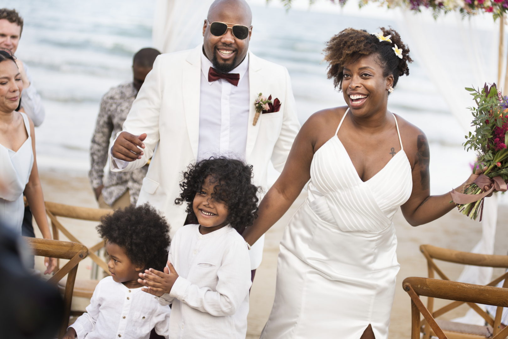 Newly weds with the guests at the beach wedding