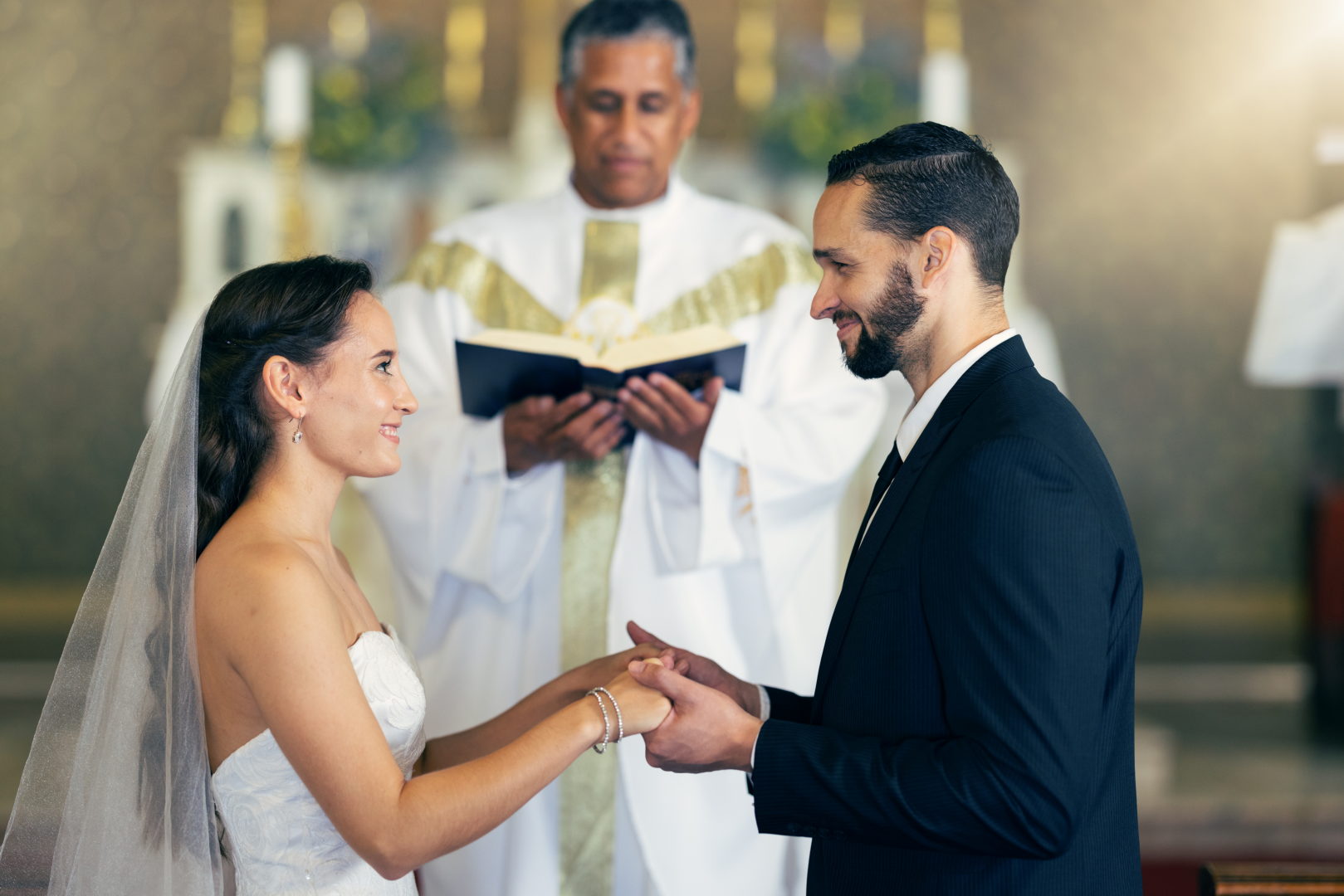 Couple getting married, wedding vows and love commitment at the alter of church during marriage cer.