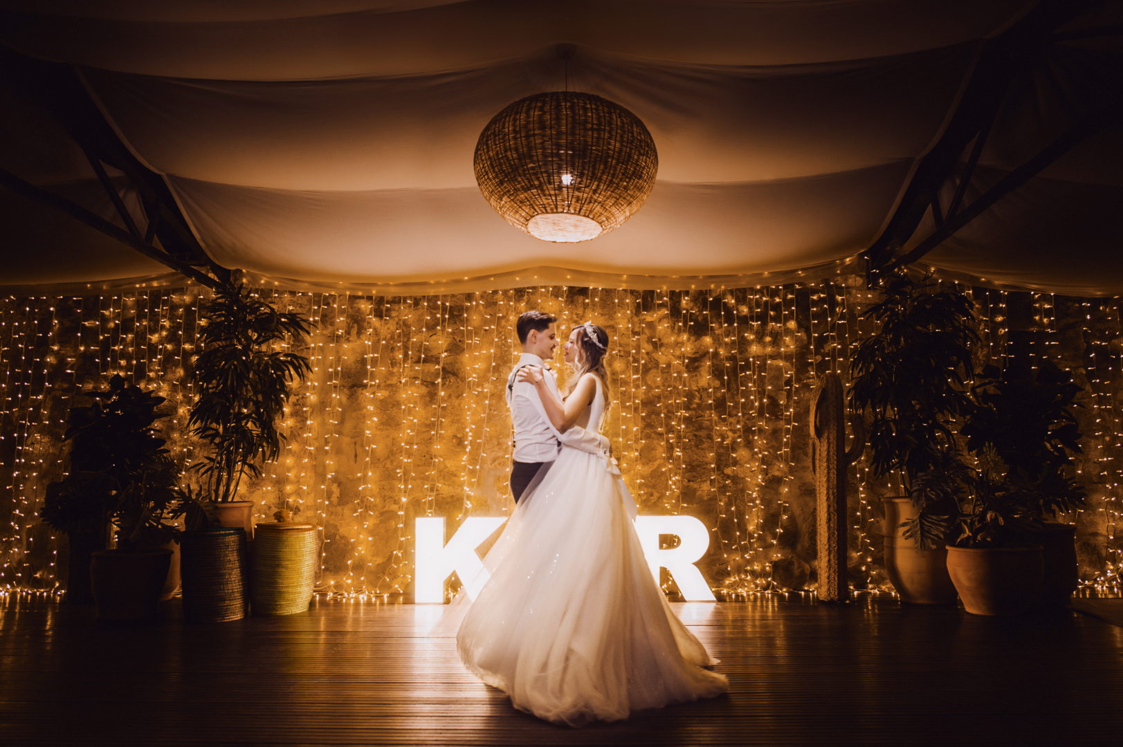 Couple dancing on their wedding day at night
